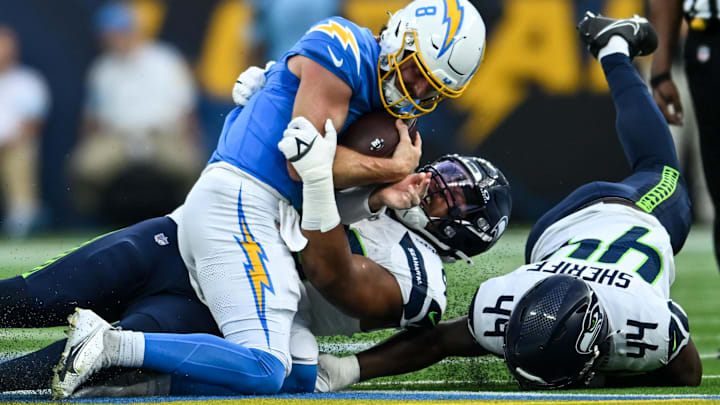 Los Angeles Chargers quarterback Max Duggan is sacked by Seattle Seahawks defensive end DeVere Levelston. Los Angeles Chargers quarterback Max Duggan is sacked by Seattle Seahawks defensive end DeVere Levelston.