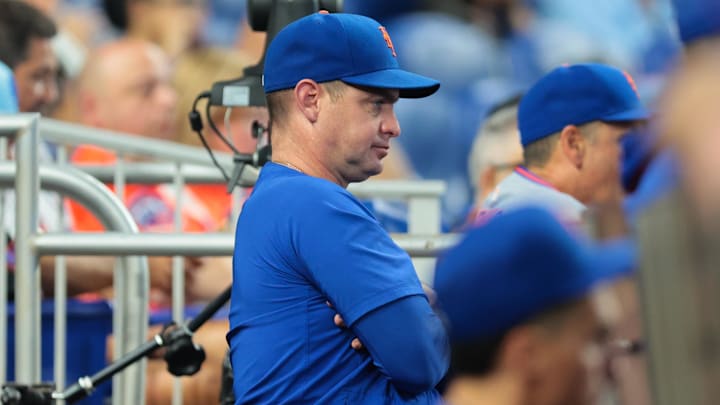 Sep 28, 2025; Miami, Florida, USA; New York Mets manager Carlos Mendoza (64) watches from the dugout against the Miami Marlins during the eighth inning at loanDepot Park. Mandatory Credit: Sam Navarro-Imagn Images Sep 28, 2025; Miami, Florida, USA; New York Mets manager Carlos Mendoza (64) watches from the dugout against the Miami Marlins during the eighth inning at loanDepot Park. Mandatory Credit: Sam Navarro-Imagn Images