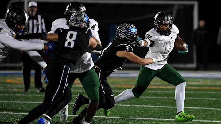 Decatur's Gavin Solito (3) tackles Milford Mill's Damon Ferguson (5) Friday, Nov. 24, 2023, in the 2A State Semifinal in Berlin, Maryland. Decatur defeated Milford Mill 35-34.