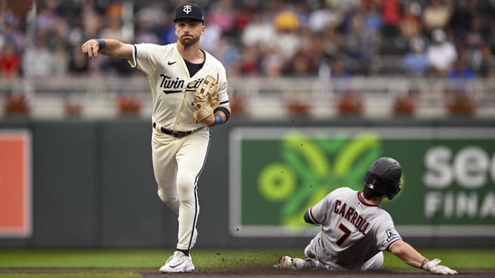 Aug 6, 2023; Minneapolis, Minnesota, USA; Minnesota Twins infielder Edouard Julien (47) throws over sliding Arizona Diamondbacks outfielder Corbin Carroll (7) to complete a double play during the first inning at Target Field. Mandatory Credit: Nick Wosika-USA TODAY Sports