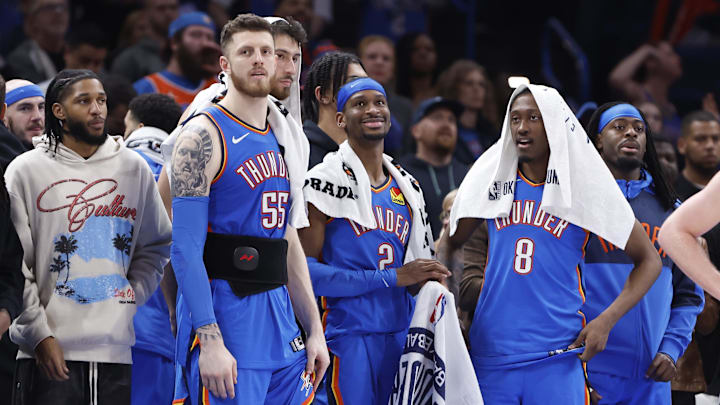 Feb 10, 2025; Oklahoma City, Oklahoma, USA; Oklahoma City Thunder guard Isaiah Joe (11), center Isaiah Hartenstein (55), forward Chet Holmgren (7), guard Shai Gilgeous-Alexander (2), forward Jalen Williams (8) and guard Luguentz Dort (5) watch the end of a game against the New Orleans Pelicans at Paycom Center. Feb 10, 2025; Oklahoma City, Oklahoma, USA; Oklahoma City Thunder guard Isaiah Joe (11), center Isaiah Hartenstein (55), forward Chet Holmgren (7), guard Shai Gilgeous-Alexander (2), forward Jalen Williams (8) and guard Luguentz Dort (5) watch the end of a game against the New Orleans Pelicans at Paycom Center.