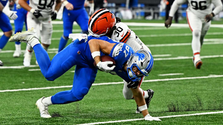 Sep 28, 2025; Detroit, Michigan, USA; Detroit Lions tight end Sam LaPorta (87) is tackled by Cleveland Browns linebacker Devin Bush (30) during the second half at Ford Field. Mandatory Credit: Lon Horwedel-Imagn Images