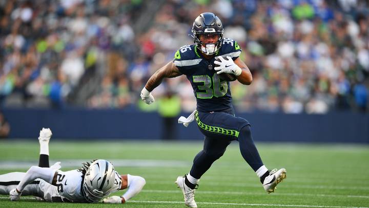 Seattle Seahawks running back George Holani (36) breaks a tackle by Las Vegas Raiders cornerback Darien Porter (26).
