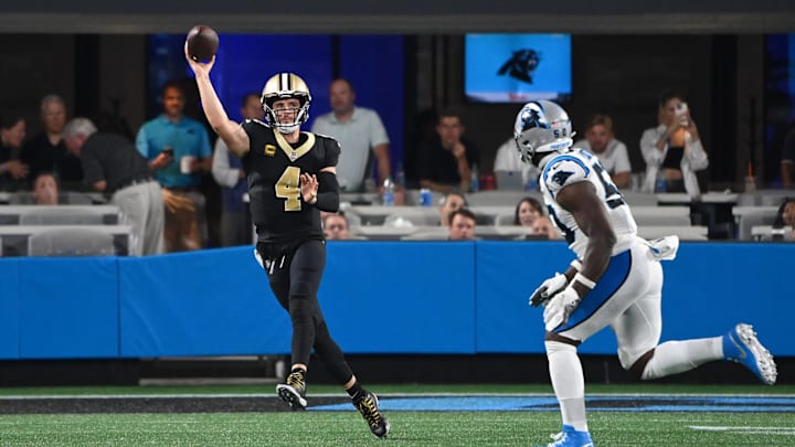 New Orleans Saints quarterback Derek Carr (4) throws on the run against the Carolina Panthers