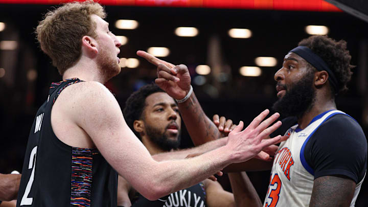 Mar 20, 2026; Brooklyn, New York, USA; New York Knicks center Mitchell Robinson (23) scuffles with Brooklyn Nets forward Danny Wolf (2) during the first half at Barclays Center. Mandatory Credit: Vincent Carchietta-Imagn Images Mar 20, 2026; Brooklyn, New York, USA; New York Knicks center Mitchell Robinson (23) scuffles with Brooklyn Nets forward Danny Wolf (2) during the first half at Barclays Center. Mandatory Credit: Vincent Carchietta-Imagn Images