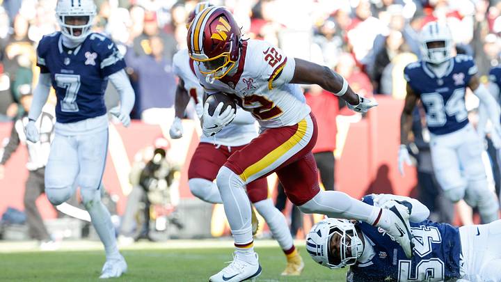 Dec 25, 2025; Landover, Maryland, USA; Washington Commanders running back Jacory Croskey-Merritt (22) avoids a tackle by Dallas Cowboys defensive end Sam Williams (54) as he carries the ball for a touchdown in the second quarter at Northwest Stadium. Mandatory Credit: Geoff Burke-Imagn Images