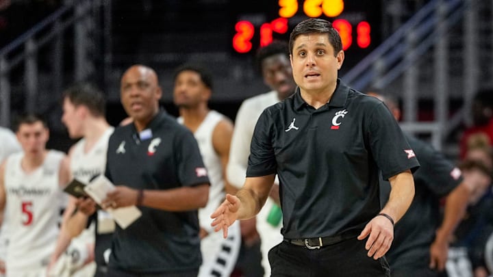 Cincinnati Bearcats head coach Wes Miller pulls in his team for a huddle in the first half of the NCAA basketball game between the Cincinnati Bearcats and the West Virginia Mountaineers at Fifth Third Arena in Cincinnati on Sunday, Feb. 2, 2025. Cincinnati Bearcats head coach Wes Miller pulls in his team for a huddle in the first half of the NCAA basketball game between the Cincinnati Bearcats and the West Virginia Mountaineers at Fifth Third Arena in Cincinnati on Sunday, Feb. 2, 2025.