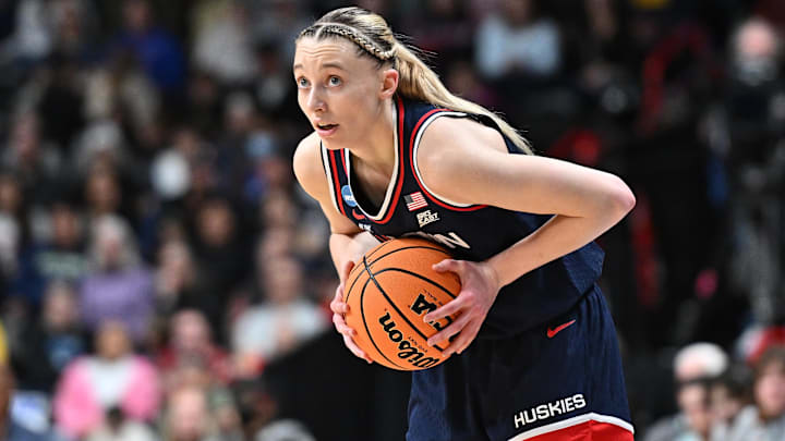 Mar 31, 2025; Spokane, WA, USA; UConn Huskies guard Paige Bueckers (5) controls the ball against the USC Trojans during the first half of a Elite 8 NCAA Tournament basketball game at Spokane Arena. Mandatory Credit: James Snook-Imagn Images