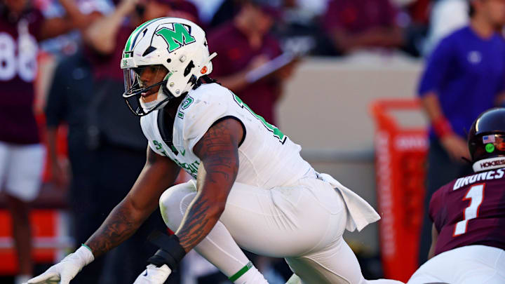 Sep 7, 2024; Blacksburg, Virginia, USA; Marshall Thundering Herd defensive lineman Mike Green (15) celebrates after sacking Virginia Tech Hokies quarterback Kyron Drones (1) during the first quarter at Lane Stadium. Mandatory Credit: Peter Casey-Imagn Images