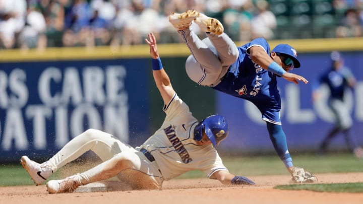 Seattle Mariners right fielder Dominic Canzone (bottom) is safe at second as Toronto Blue Jays second baseman Leo Jimenez (top) tumbles over on July 7 at T-Mobile Park. Seattle Mariners right fielder Dominic Canzone (bottom) is safe at second as Toronto Blue Jays second baseman Leo Jimenez (top) tumbles over on July 7 at T-Mobile Park.