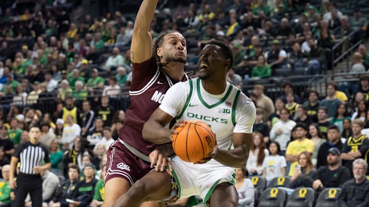 Oregon guard TJ Bamba presses toward the basket under cover from Montana guard Joe Pridgen as the Oregon Ducks host the Montana Grizzlies at Matthew Knight Arena Friday, Nov. 8, 2024 in Eugene, Ore.