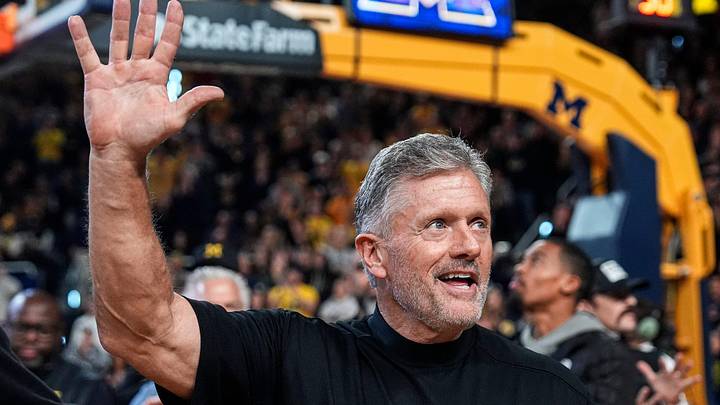 Michigan football head coach Kyle Whittingham waves at the crowd as he is being introduced on the floor during the first half between Michigan and USC at Crisler Center in Ann Arbor on Friday, Jan. 2, 2026.