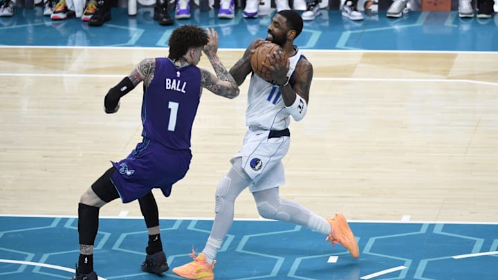 Jan 20, 2025; Charlotte, North Carolina, USA; Dallas Mavericks guard Kyrie Irving (11) drives past Charlotte Hornets guard LaMelo Ball (1) during the second half at the Spectrum Center. Mandatory Credit: Sam Sharpe-Imagn Images Jan 20, 2025; Charlotte, North Carolina, USA; Dallas Mavericks guard Kyrie Irving (11) drives past Charlotte Hornets guard LaMelo Ball (1) during the second half at the Spectrum Center. Mandatory Credit: Sam Sharpe-Imagn Images