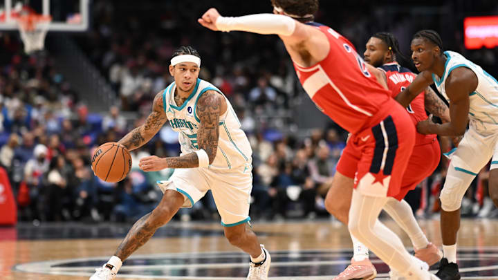 Oct 26, 2025; Washington, District of Columbia, USA; Charlotte Hornets guard Tre Mann (23) dribbles the ball in front of Washington Wizards forward Corey Kispert (24) during the fourth quarter at Capital One Arena. Mandatory Credit: Rafael Suanes-Imagn Images