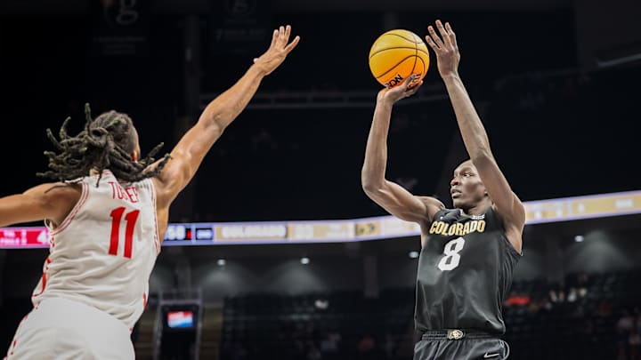 Mar 13, 2025; Kansas City, MO, USA; Colorado Buffaloes forward Bangot Dak (8) shoots the ball over Houston Cougars forward Joseph Tugler (11) during the second half at T-Mobile Center. Mandatory Credit: William Purnell-Imagn Images Mar 13, 2025; Kansas City, MO, USA; Colorado Buffaloes forward Bangot Dak (8) shoots the ball over Houston Cougars forward Joseph Tugler (11) during the second half at T-Mobile Center. Mandatory Credit: William Purnell-Imagn Images