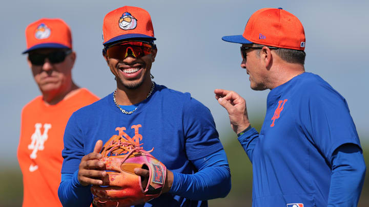 Feb 15, 2025; Port St. Lucie, FL, USA; New York Mets shortstop Francisco Lindor (12) talks to third base coach Mike Sarbaugh (88) during a spring training workout at Clover Park. Mandatory Credit: Sam Navarro-Imagn Images