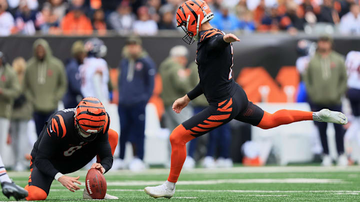 Nov 2, 2025; Cincinnati, Ohio, USA; Cincinnati Bengals placekicker Evan McPherson (2) kicks a 41-yard field goal held by punter Ryan Rehkow (8) against the Chicago Bears during the first quarter at Paycor Stadium. Mandatory Credit: Katie Stratman-Imagn Images