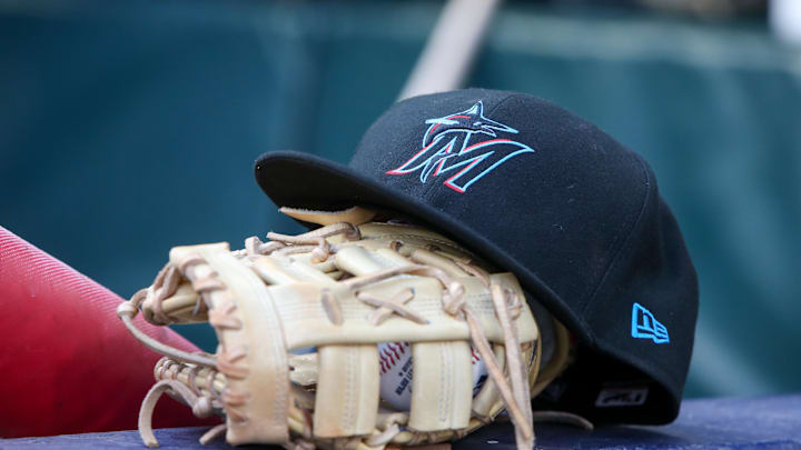 Apr 24, 2024; Atlanta, Georgia, USA; A detailed view of a Miami Marlins hat and glove in the dugout before a game against the Atlanta Braves at Truist Park. Apr 24, 2024; Atlanta, Georgia, USA; A detailed view of a Miami Marlins hat and glove in the dugout before a game against the Atlanta Braves at Truist Park.