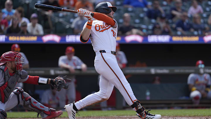 May 26, 2025; Baltimore, Maryland, USA; Baltimore Orioles right fielder Ryan O'Hearn (32) hits a single against the St. Louis Cardinals during the fourth inning at Oriole Park at Camden Yards.