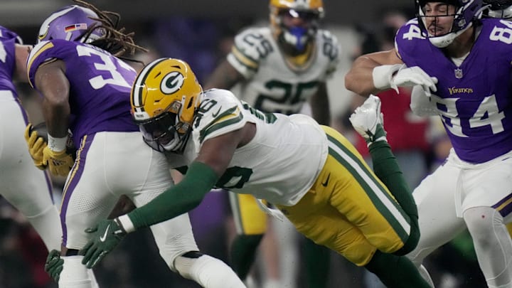 Green Bay Packers linebacker Edgerrin Cooper (56) tackles Minnesota Vikings running back Aaron Jones (33) for a one-yard loss during the first quarter of their game Sunday, December 29, 2024 at U.S. Bank Stadium in Minneapolis, Minnesota.