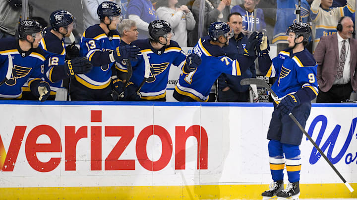 Mar 23, 2025; St. Louis, Missouri, USA;  St. Louis Blues center Alexandre Texier (9) is congratulated by teammates after scoring against the Nashville Predators during the first period at Enterprise Center. Mandatory Credit: Jeff Curry-Imagn Images