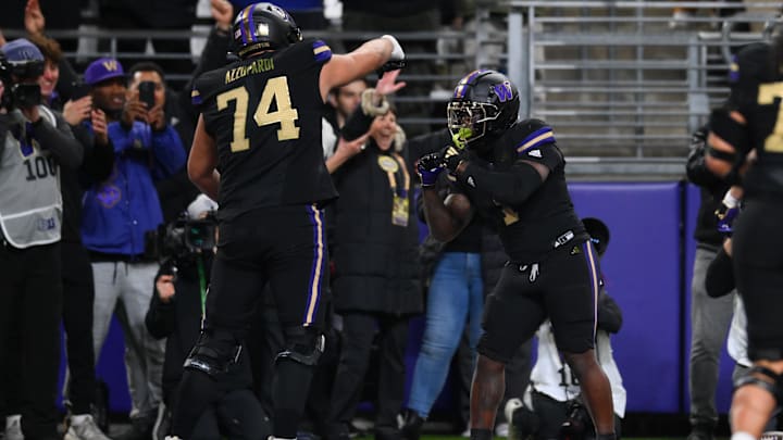 Nov 15, 2024; Seattle, Washington, USA; Washington Huskies offensive lineman Drew Azzopardi (74) and running back Jonah Coleman (1) celebrate after Coleman scored a touchdown against the UCLA Bruins during the first half at Alaska Airlines Field at Husky Stadium. Mandatory Credit: Steven Bisig-Imagn Images