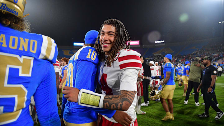 Nebraska quarterback TJ Lateef (14) meets with UCLA backup quarterback Madden Iamaleava after Saturday's game.