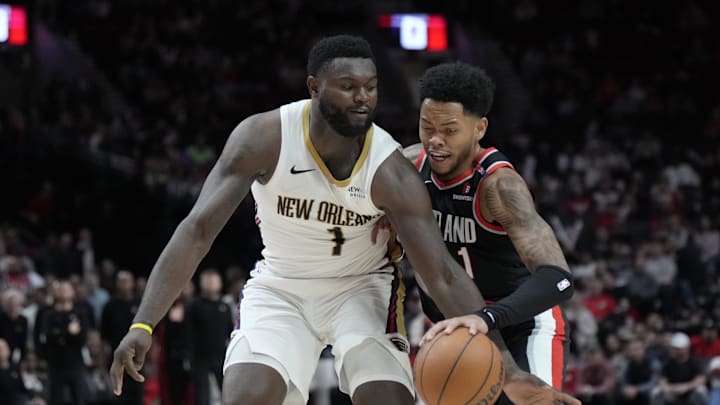 Oct 25, 2024; Portland, Oregon, USA; Portland Trail Blazers shooting guard Anfernee Simons (1) dribbles the ball while defended by New Orleans Pelicans power forward Zion Williamson (1) during the second half at Moda Center. Mandatory Credit: Soobum Im-Imagn Images