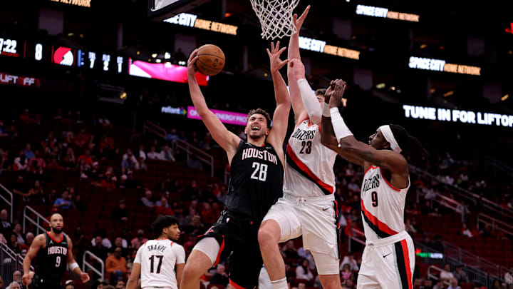 Nov 22, 2024; Houston, Texas, USA; Houston Rockets center Alperen Sengun (28) drives to the basket against Portland Trail Blazers center Donovan Clingan (23) during the first quarter at Toyota Center. Mandatory Credit: Erik Williams-Imagn Images