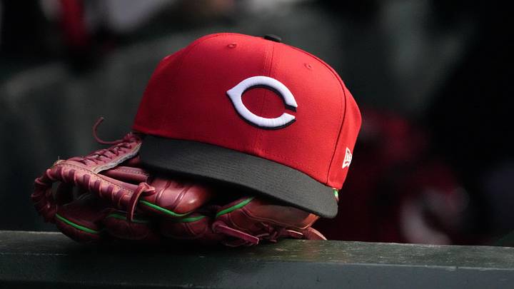 May 5, 2026; Chicago, Illinois, USA; A detail shot of Cincinnati Reds hat and glove in the dugout during the fourth inning against the Chicago Cubs at Wrigley Field. Mandatory Credit: David Banks-Imagn Images