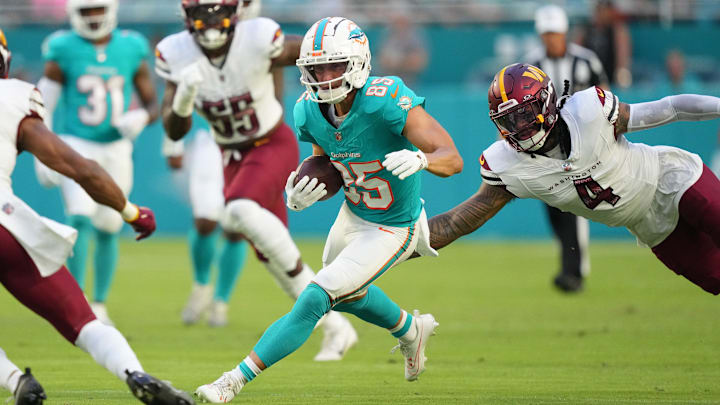 Miami Dolphins wide receiver River Cracraft (85) runs against Washington Commanders linebacker Frankie Luvu (4) during the first quarter at Hard Rock Stadium. Miami Dolphins wide receiver River Cracraft (85) runs against Washington Commanders linebacker Frankie Luvu (4) during the first quarter at Hard Rock Stadium.