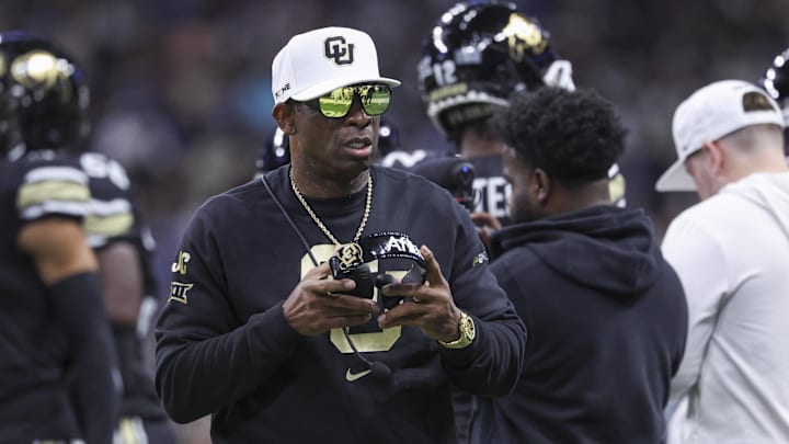 Colorado Buffaloes head coach Deion Sanders walks on the field between plays during the first quarter against the Brigham Young Cougars at Alamodome.