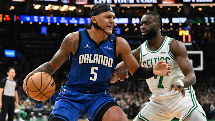Orlando Magic forward Paolo Banchero (5) is defended by Boston Celtics guard Jaylen Brown (7) during the first half at TD Garden.