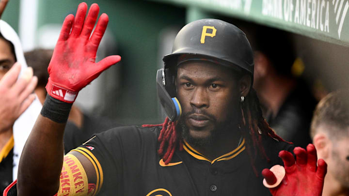 Aug 30, 2025; Boston, Massachusetts, USA; Pittsburgh Pirates center fielder Oneil Cruz (15) high-fives his teammates after hitting a solo home run against the Boston Red Sox during the fifth inning at Fenway Park. Mandatory Credit: Brian Fluharty-Imagn Images