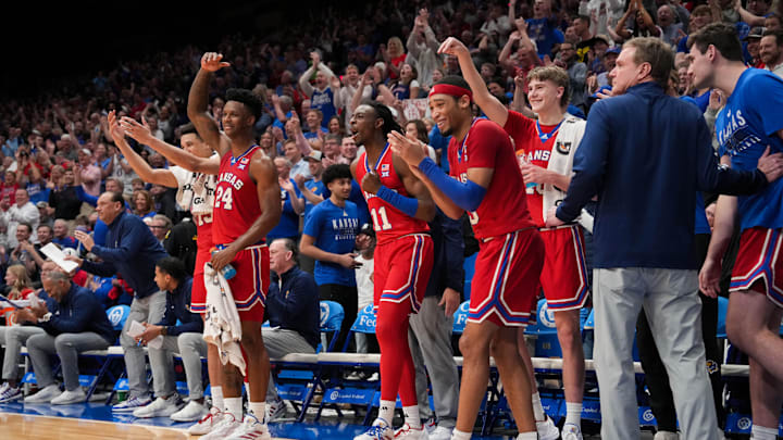 Mar 5, 2024; Lawrence, Kansas, USA; Kansas Jayhawks players and coaches celebrate from the bench
