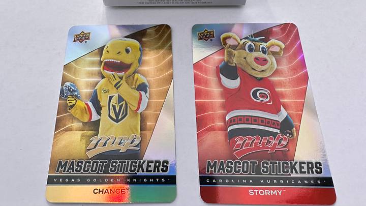 Mascots, Chance and Stormy, from the 2025-26 Stanley Cup finalists featured on 'Mascot Stickers' cards from the Upper Deck MVP set are pictured in front of a blaster box like the ones from which these cards emerged. Mascots, Chance and Stormy, from the 2025-26 Stanley Cup finalists featured on 'Mascot Stickers' cards from the Upper Deck MVP set are pictured in front of a blaster box like the ones from which these cards emerged.
