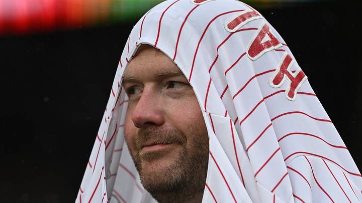 Jul 10, 2026; Detroit, Michigan, USA;  A Philadelphia Phillies’ fan pulls his jersey over his head during a rain shower in the fifth inning of their game against the Detroit Tigers at Comerica Park. Mandatory Credit: Lon Horwedel-Imagn Images