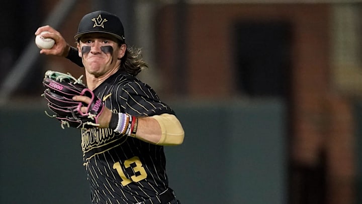 Vanderbilt shortstop Jonathan Vastine (13) fields a ground out hit by Arkansas third baseman Brent Iredale (10) during the ninth inning at Hawkins Field in Nashville, Tenn., Friday, March 28, 2025. Vanderbilt shortstop Jonathan Vastine (13) fields a ground out hit by Arkansas third baseman Brent Iredale (10) during the ninth inning at Hawkins Field in Nashville, Tenn., Friday, March 28, 2025.