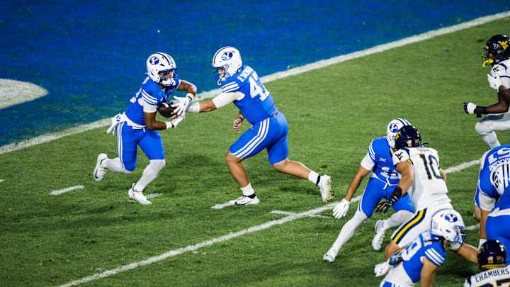 BYU RB Jovesa Damuni takes a handoff from Bear Bachmeier against WVU