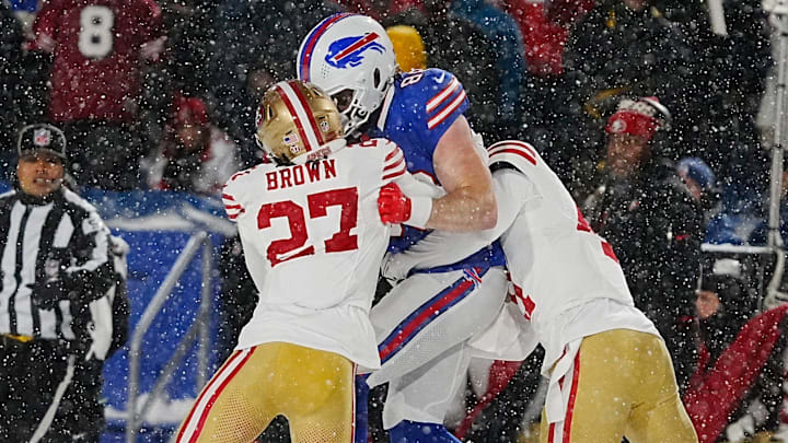 Bills Dawson Knox gets tackled by a couple of 49ers including Ji'Ayir Brown during first half action of their home game against the San Francisco 49ers in Orchard Park on Dec. 1, 2024.