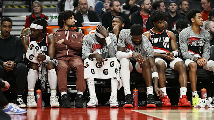 Mar 11, 2024; Portland, Oregon, USA; The Portland Trail Blazers bench, from left, guard Malcolm Brogdon (11), guard Shaedon Sharpe (17), center Duop Reath (26), center Deandre Ayton (2), guard Scoot Henderson (00), and guard Anfernee Simons (1) watch the final minutes of a game against the Boston Celtics at Moda Center. Mandatory Credit: Troy Wayrynen-Imagn Images Mar 11, 2024; Portland, Oregon, USA; The Portland Trail Blazers bench, from left, guard Malcolm Brogdon (11), guard Shaedon Sharpe (17), center Duop Reath (26), center Deandre Ayton (2), guard Scoot Henderson (00), and guard Anfernee Simons (1) watch the final minutes of a game against the Boston Celtics at Moda Center. Mandatory Credit: Troy Wayrynen-Imagn Images