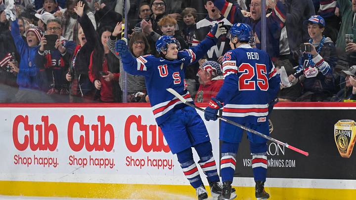 Dec 31, 2025; St. Paul, Minnesota, USA; USA defensemen Chase Reid (25) celebrates his power play goal against Sweden with forward James Hagens (10) during the second period in group play during the 2026 IIHF World Junior Championship at Grand Casino Arena. Mandatory Credit: Nick Wosika-Imagn Images