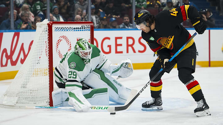 Nov 20, 2025; Vancouver, British Columbia, CAN; Dallas Stars goalie Jake Oettinger (29) makes a save on Vancouver Canucks forward Kiefer Sherwood (44) in the second period at Rogers Arena. Mandatory Credit: Bob Frid-Imagn Images