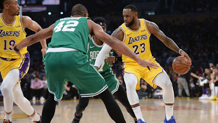 March 9, 2019; Los Angeles, CA, USA; Los Angeles Lakers forward LeBron James (23) moves the ball against Boston Celtics center Al Horford (42) during the first half at Staples Center. Mandatory Credit: Gary A. Vasquez-Imagn Images