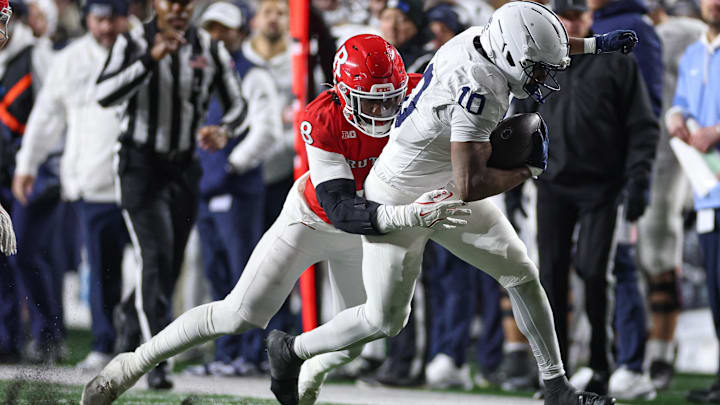 Penn State running back Nicholas Singleton pushes ahead for yardage against Rutgers.