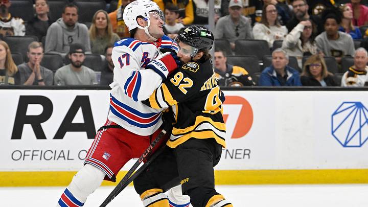 Oct 4, 2025; Boston, Massachusetts, USA; New York Rangers defenseman Will Borgen (17) pushes Boston Bruins center Marat Khusnutdinov (92) off the puck during the third period period at TD Garden. Mandatory Credit: Eric Canha-Imagn Images