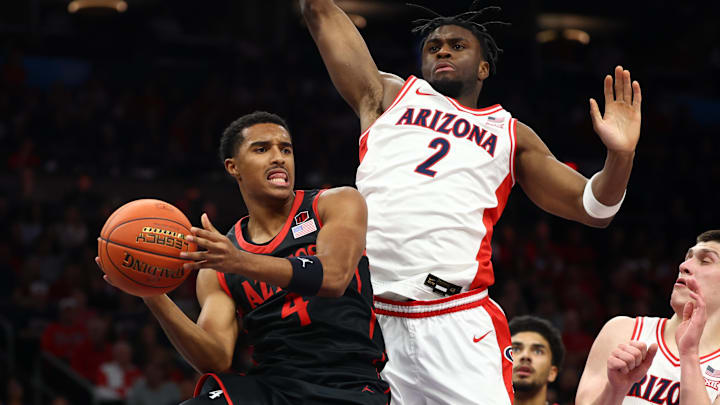 San Diego State Aztecs guard Sean Newman Jr. (4) passes the ball against Arizona Wildcats forward Dwayne Aristode (2). San Diego State Aztecs guard Sean Newman Jr. (4) passes the ball against Arizona Wildcats forward Dwayne Aristode (2).
