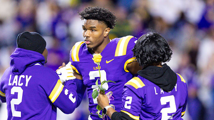 Nov 30, 2024; Baton Rouge, Louisiana, USA;  LSU Tigers wide receiver Kyren Lacy (2) hugs his family as seniors are being honored during the beginning of the first quarter at Tiger Stadium. Mandatory Credit: Stephen Lew-Imagn Images