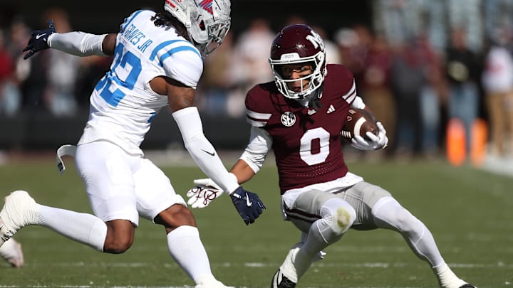 Nov 28, 2025; Starkville, Mississippi, USA; Mississippi State Bulldogs wide receiver Brenen Thompson (0) runs against Mississippi Rebels defensive back Chris Graves Jr. (32) in the first half at Davis Wade Stadium at Scott Field. Mandatory Credit: Petre Thomas-Imagn Images
