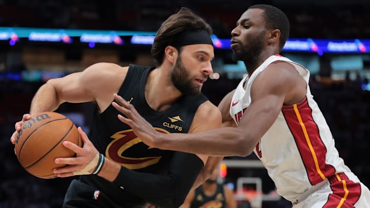 Apr 26, 2025; Miami, Florida, USA; Cleveland Cavaliers guard Max Strus (1) protects the basketball from Miami Heat forward Andrew Wiggins (22) in the first quarter during game three for the first round of the 2025 NBA Playoffs at Kaseya Center. Mandatory Credit: Sam Navarro-Imagn Images